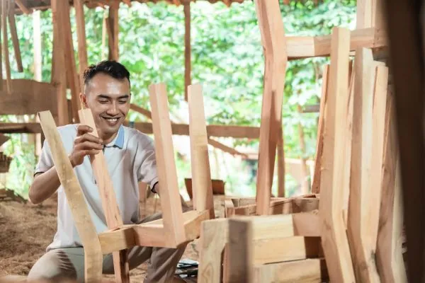 carpenters work using sand paper to smooth wood surfaces