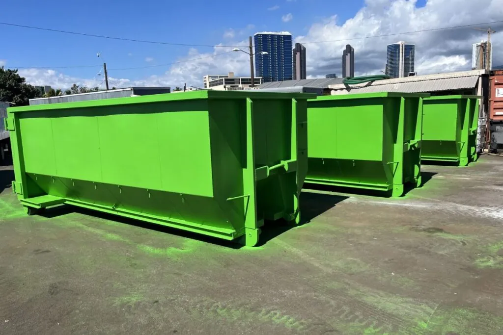 3 green 20 yard dumpsters on commercial area