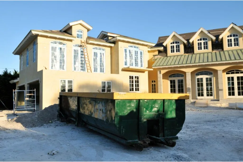 dumpster and construction house